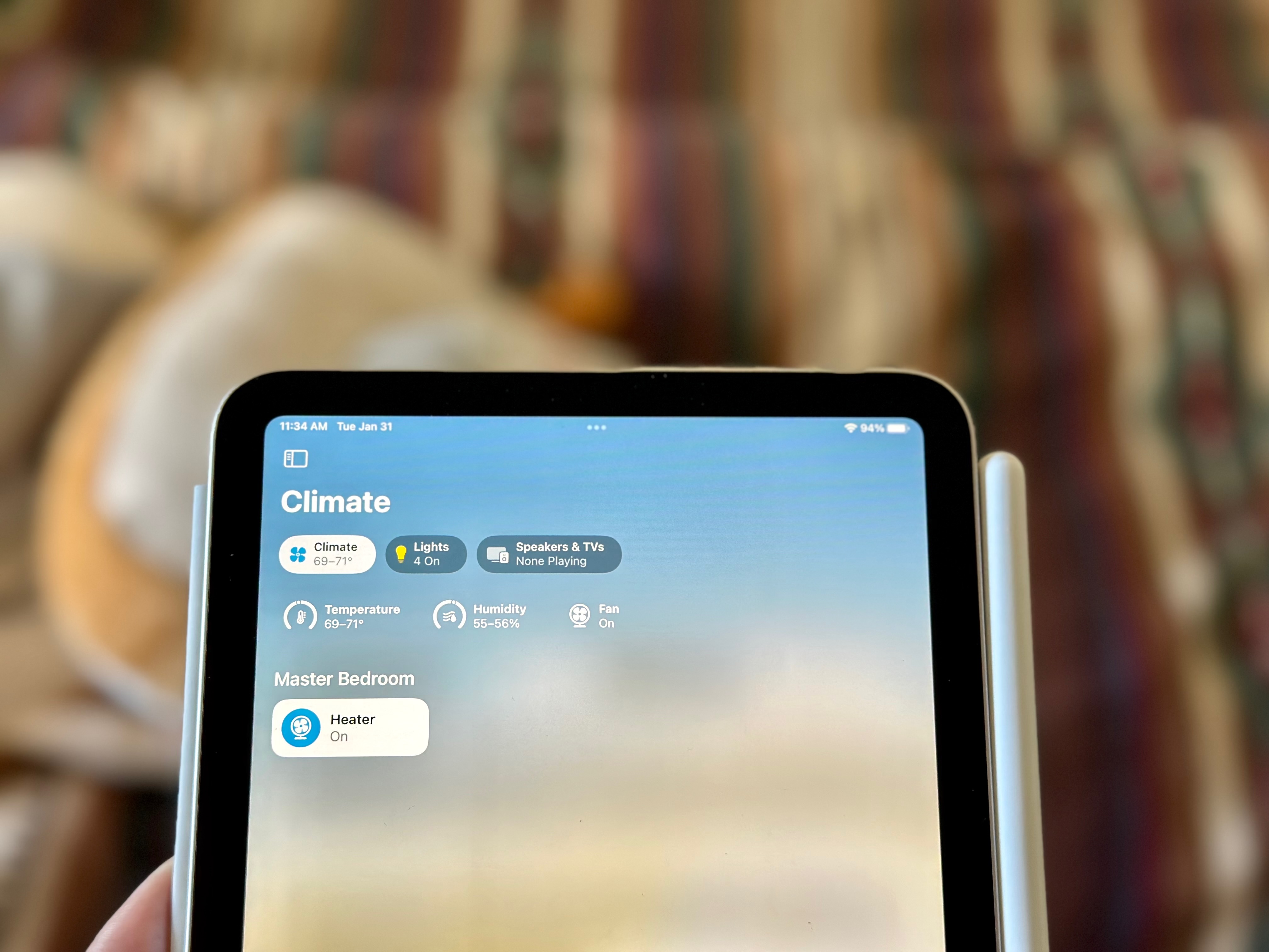 "iPad mini displaying the Apple Home app with humidity and temperature at the top"